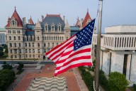 Why has N.Y. Gov. Hochul ordered flags at half staff?