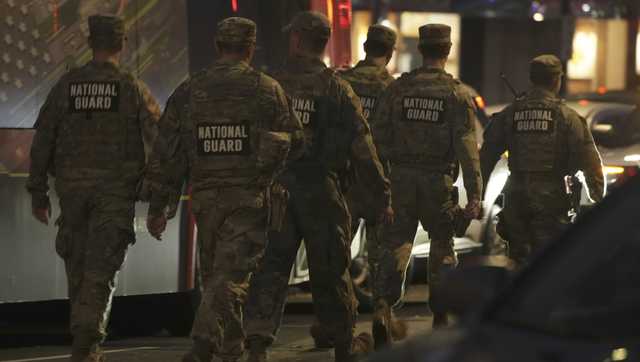 Suspect in shooting of National Guard members faces murder charge as US halts all asylum decisions