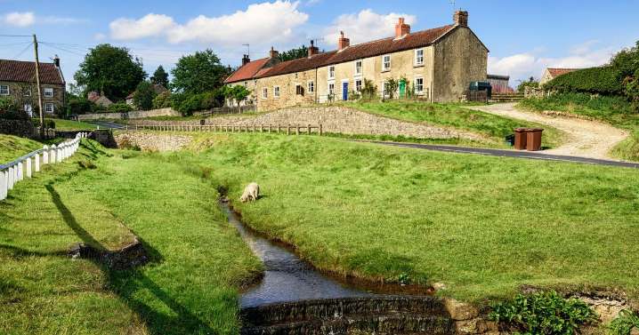Idyllic and enchanting village with red cottages and babbling brook