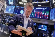 Wall Street gains ground amid steady flow of earnings reports, upbeat economic updates