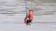 Farmer suspended on zipwire in attempt to escape flood