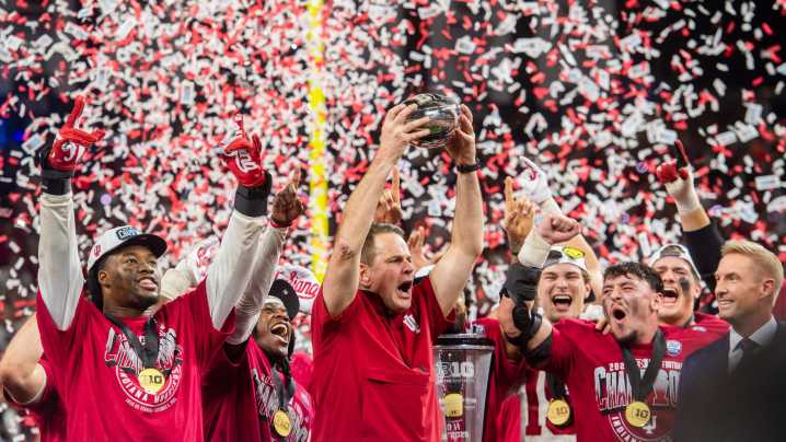 Indiana football players lead fans in a sing-along after winning Big Ten title