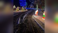 Vehicles drive through Whiteland Christmas light display