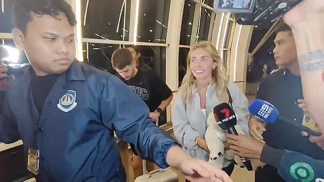 Bonnie Blue’s parting shot during deportation as she is marched through Bali airport