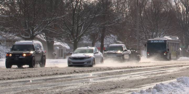 Holiday travelers take on busy and slick roads