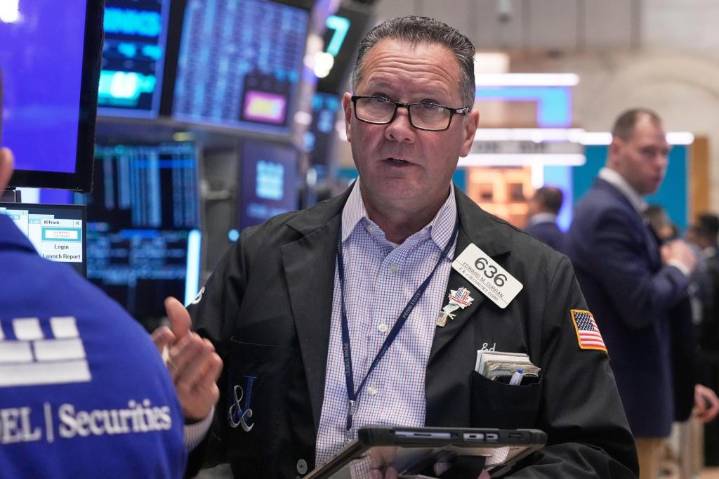 Wall Street hangs near its records as the battle to buy Warner Bros. heats up