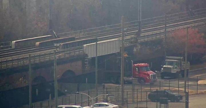 Stuck truck disrupts trains