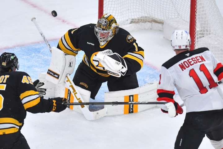 Bruins score two goals late to pull away from Devils