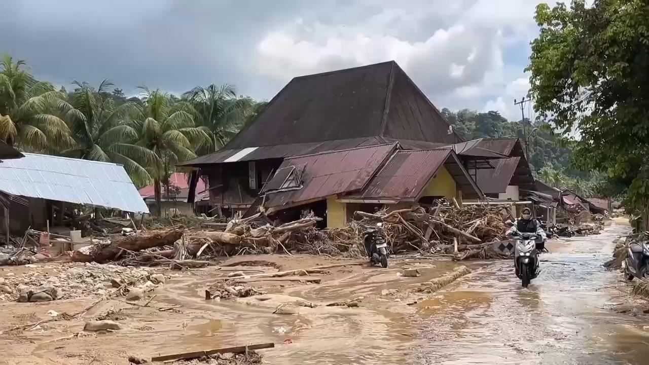 Survivors reflect on Indonesia's floods as receding water reveals swathe of destruction