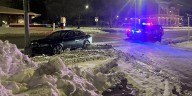 Car slides into pole due to icy roads, police say