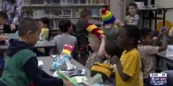 Group of 2nd graders in Ashwaubenon receive knitted winter hats that they designed