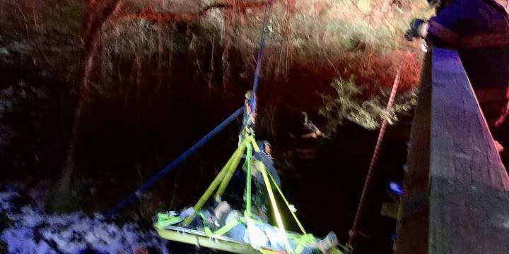 Driver rescued from crash over bridge