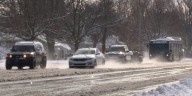 Holiday travelers take on busy and slick roads