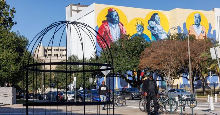 A giant birdcage appears outside New Orleans City Hall, calling attention to ICE raids