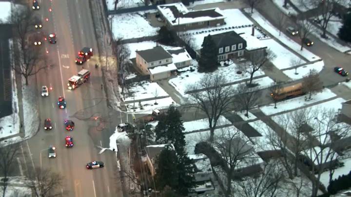 Vehicle appears incinerated after crash involving school bus