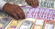 Indian rupee sinks to record low of 90.4 per US dollar