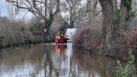 Stranded motorist rescued by firefighters after driving into flood water in Shropshire village