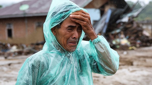Indonesian man searches for missing wife after devastating floods