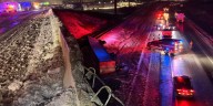 Semi truck driver survives crash off of I