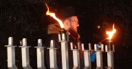 Photos: Rabbi Shaul Shkedi lights a Hanukkah menorah on Sunday