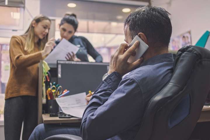 Miss Manners: How can I get my co-workers to be quiet during important calls?