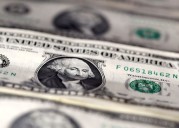 Dollar staggers to third straight weekly drop as investors ponder Fed outlook