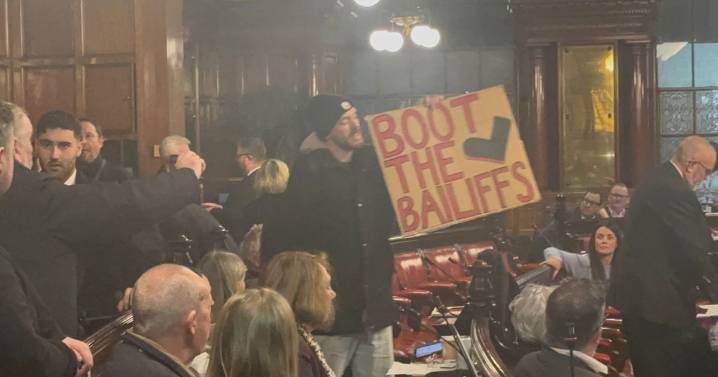 Man shouts 'take your hands off me' as protestors removed from Town Hall