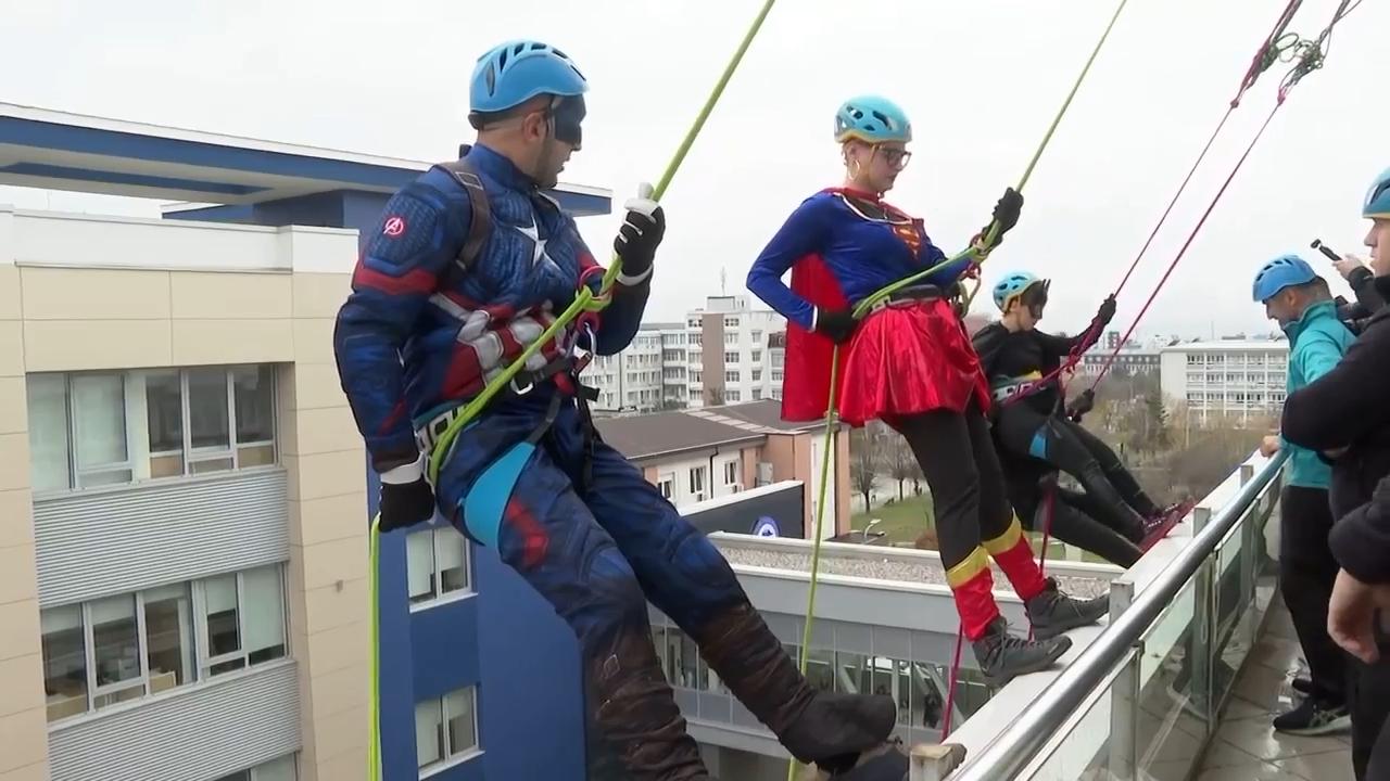 Superhero volunteers put a smile on faces of hospitalized children by climbing down clinic in Kosovo