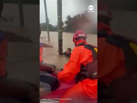 Rescuers save men clinging to trees amid deadly flooding in Indonesia