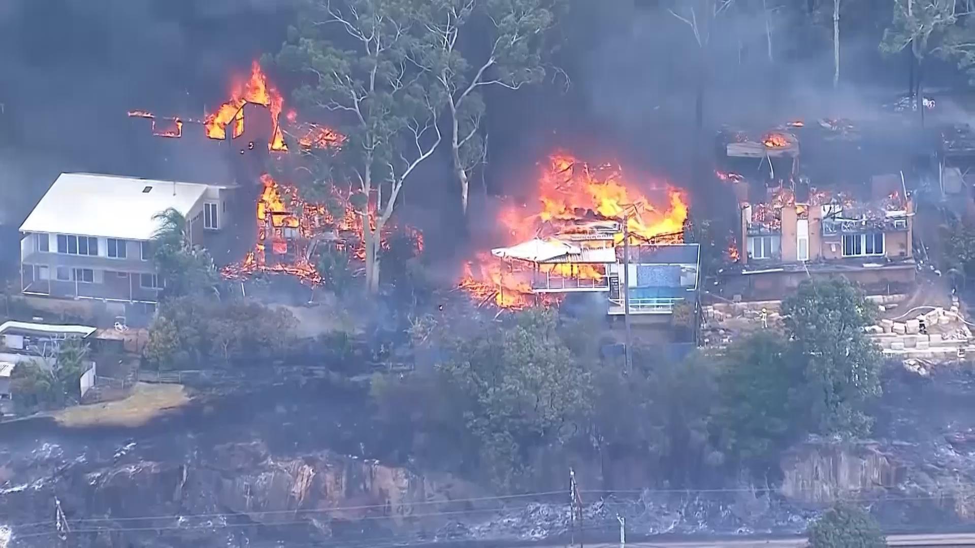 At least 12 homes damaged or destroyed in wildfire north of Sydney, Australia