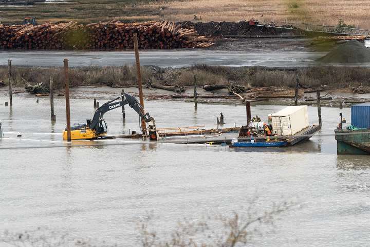 Barge with excavator goes under in Snohomish River