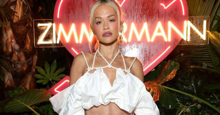 Rita Ora’s Micro Shorts Photo Show Top Held up by Just a String