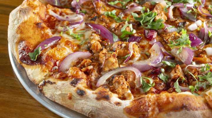 The Unexpected Pizza Topping That Belongs Under The Sauce