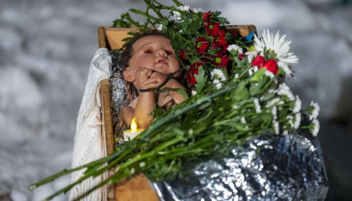 Altered church Nativity scenes, one with a zip-tied baby Jesus, critique Trump's deportation campaign