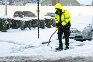 Snowfall blankets NYC, causing airport delays, some power outages