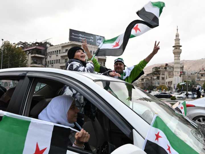 Celebrations, military parade mark one year since fall of Assad