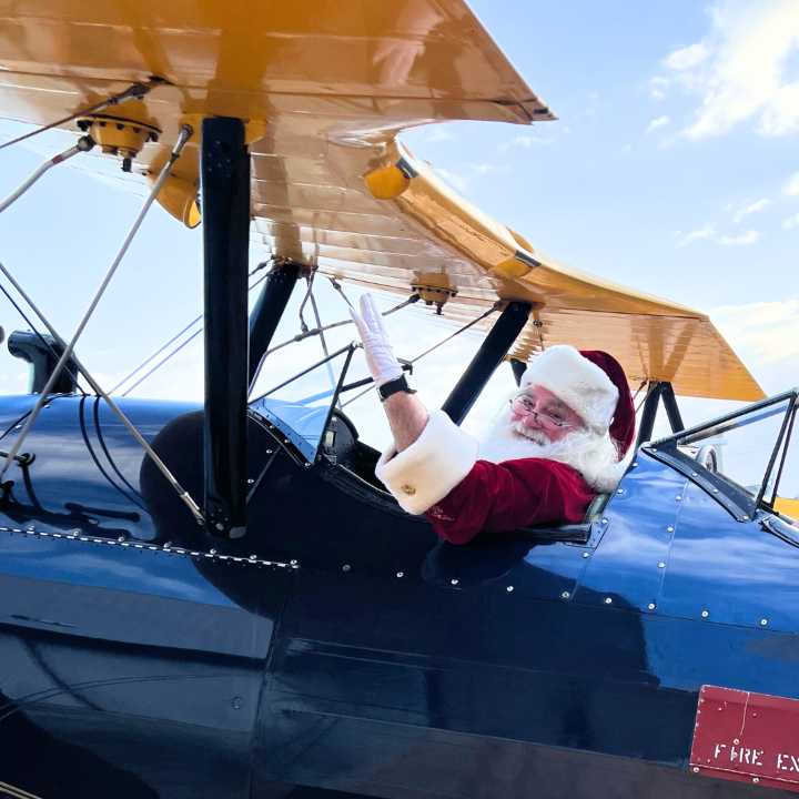 Stearman Santa – Santa arrives in a World War II open cockpit Stearman biplane. 10 am to 1 pm