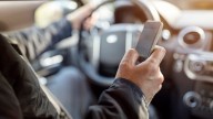 Is it legal to use your cellphone at a red light in Delaware?
