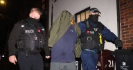 Police smash down door in raids over 'one of UK's largest drug conspiracies'