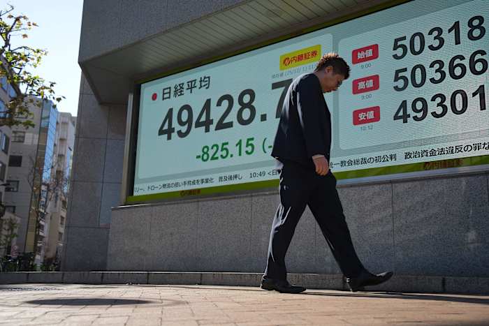 US futures slip and Asian stocks are mixed, while oil prices surge more than $1 a barrel