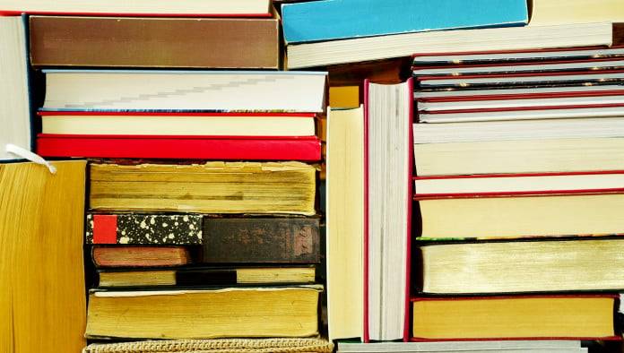 Seminarian Unable To Locate Bible Among Towering Stacks Of Theology Books