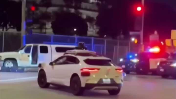 Bystander video shows Waymo obliviously driving through LAPD standoff