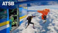 Dramatic video shows moment a skydiver's parachute gets caught on plane's tail