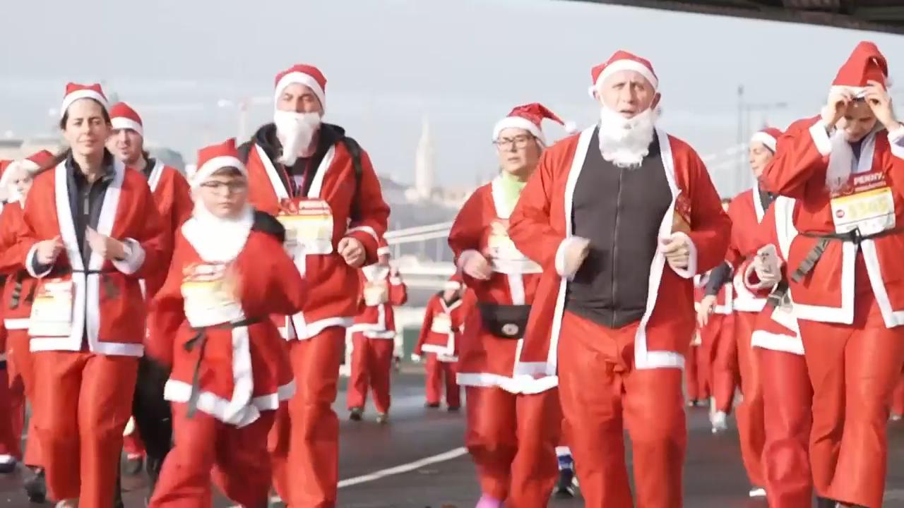 Thousands of runners in Santa costumes jog the streets of Budapest