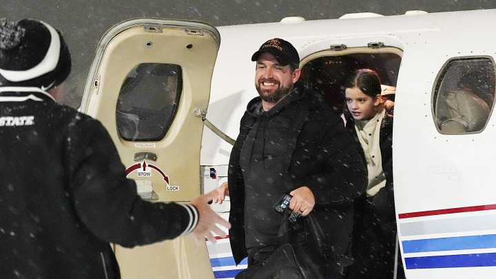 Photos, Iowa State football coach Jimmy Rogers arrives at Ames airport