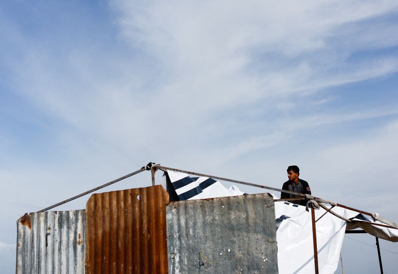 Desperate Gazans pull iron bars from rubble to construct tents and scratch out a living