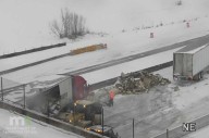 Semi trailer crash spills wood pallets onto I