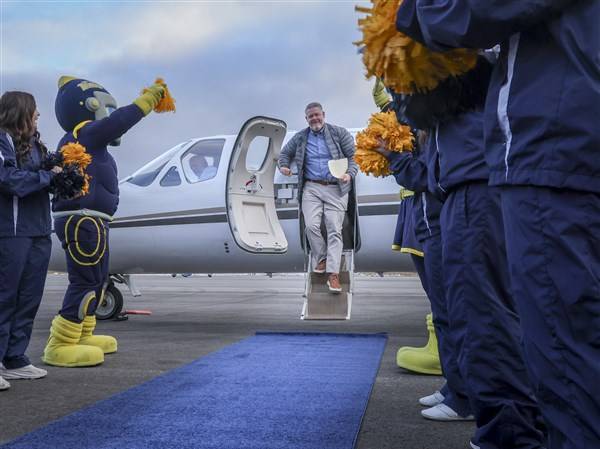 Photo Gallery: New Toledo football coach Mike Jacobs arrives at airport