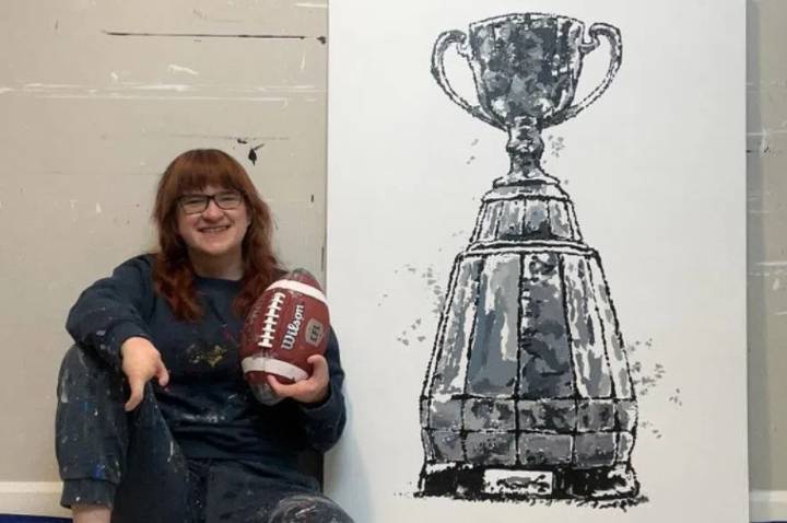 Artist Samantha Woj painted Grey Cup work using CFL ball