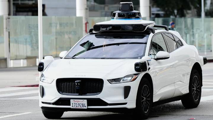 Watch: Driverless Waymo taxi rolls into active LAPD standoff in Los Angeles